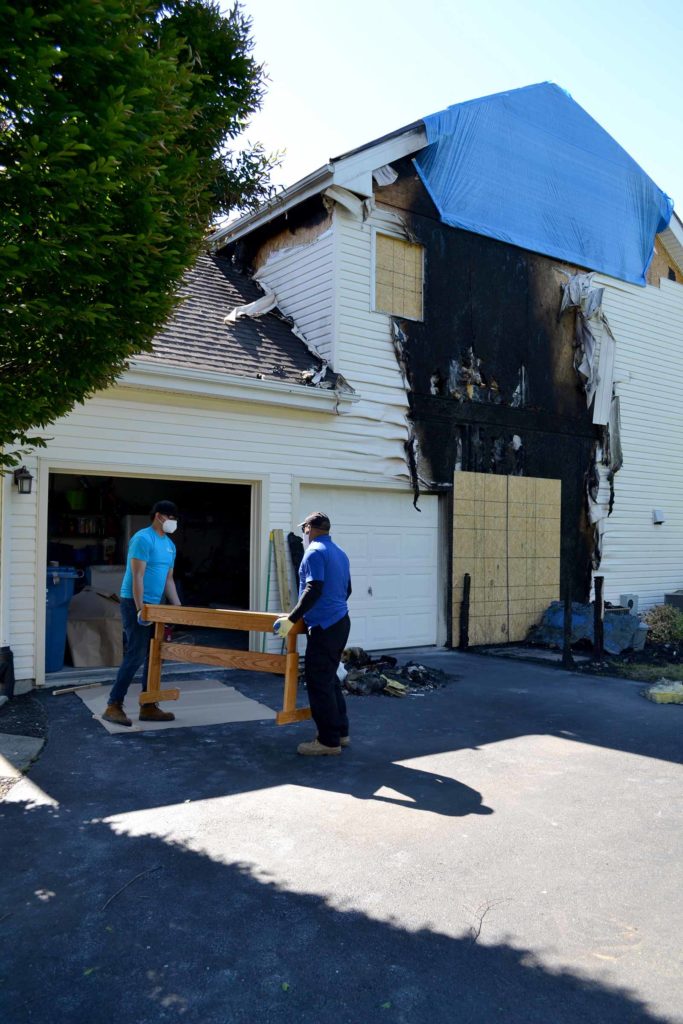 Blue Kangaroo Packoutz contents packout franchise two men remove contents from burned house essential service